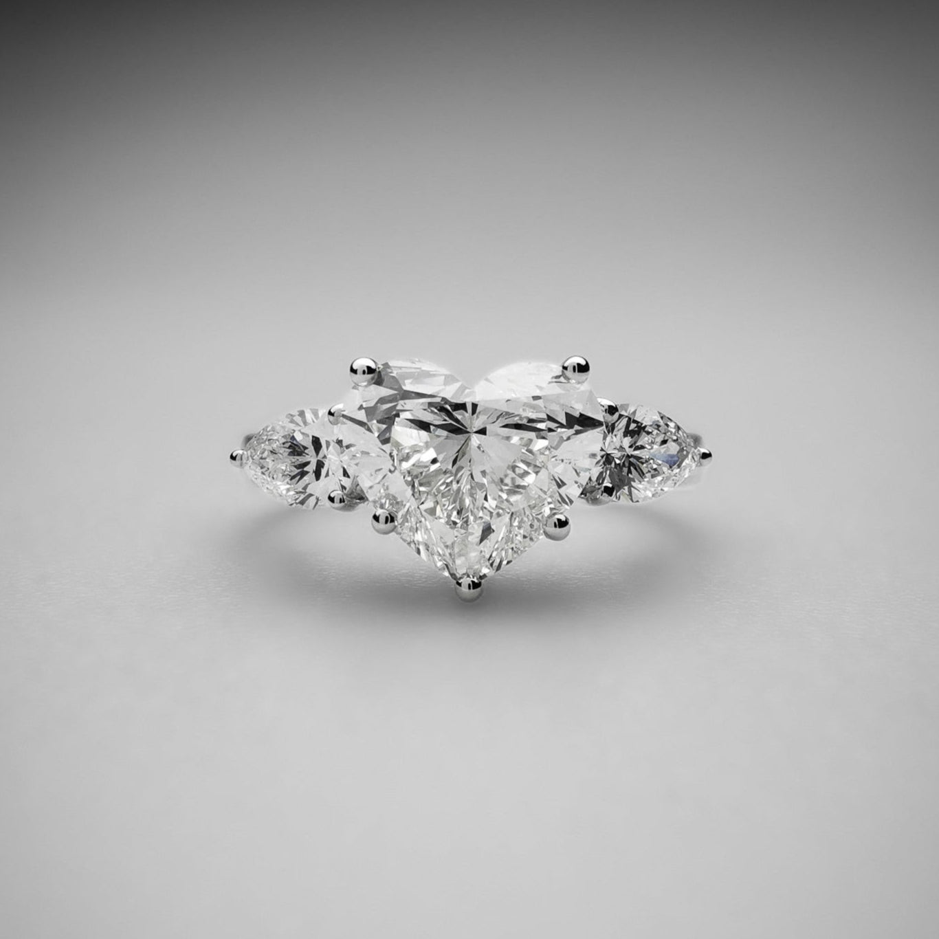 Heart cut diamond ring with pear side stones