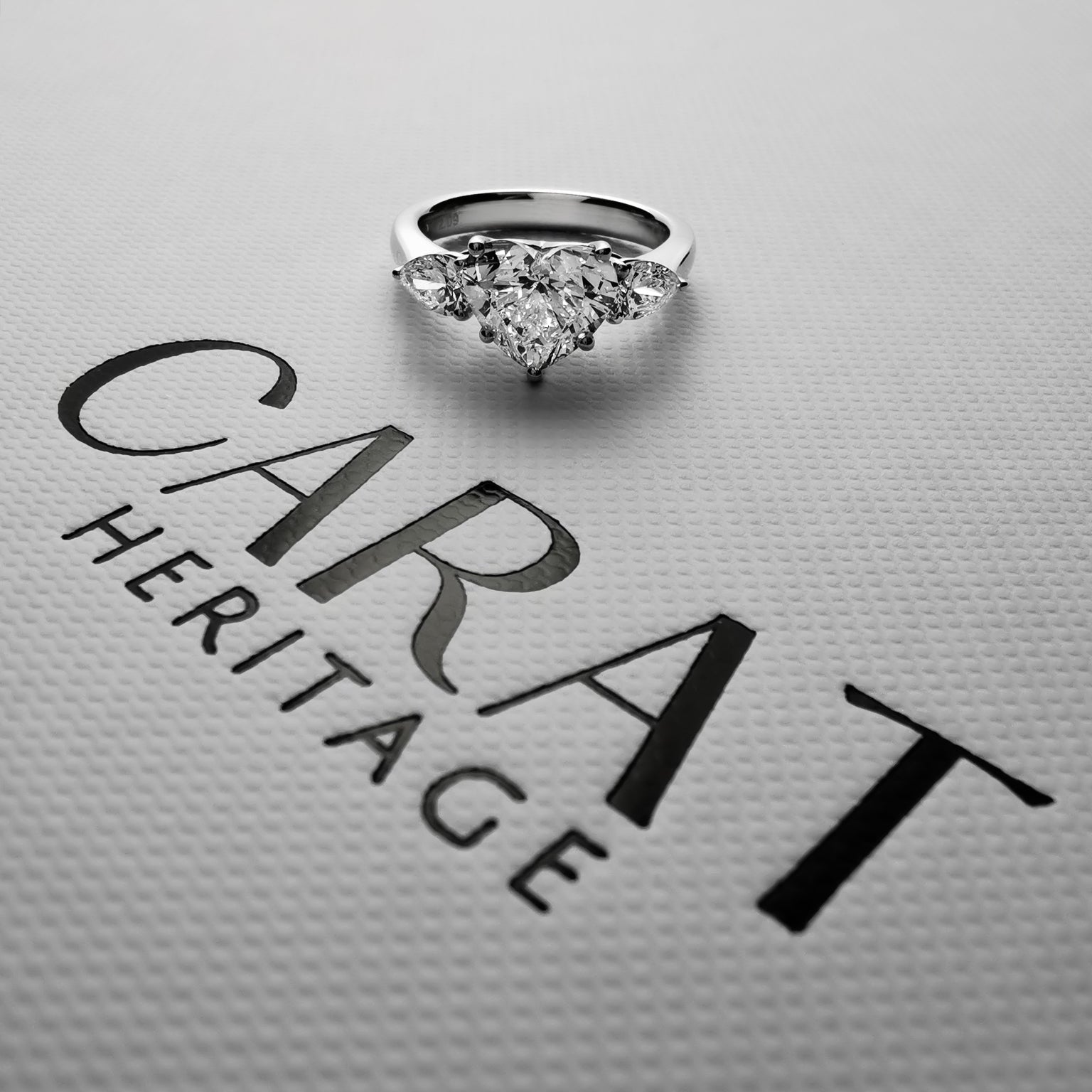 Heart shaped diamond ring with pear side stones on Carat Heritage