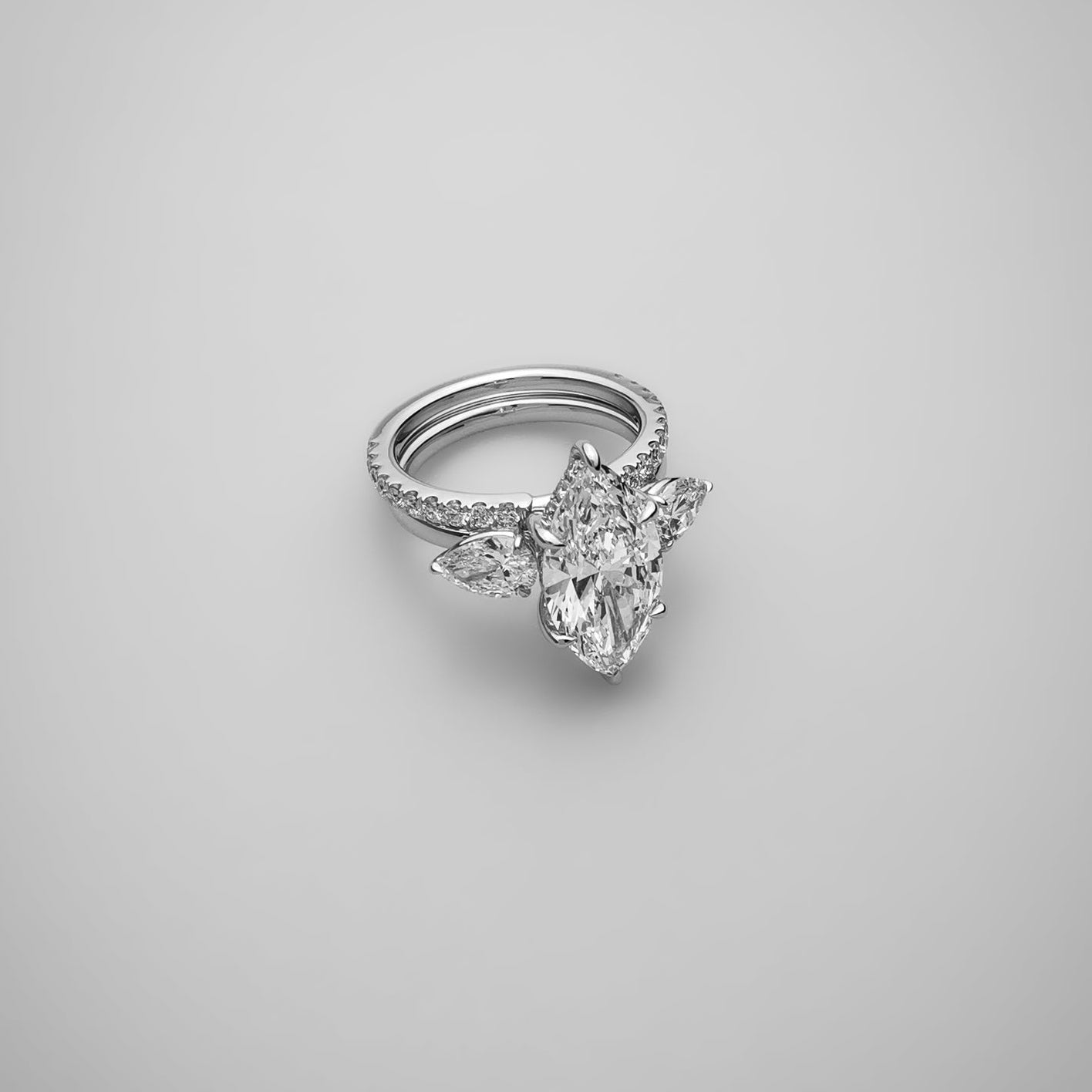 3 carat marquise diamond ring with pear side stones stacked with eternity band