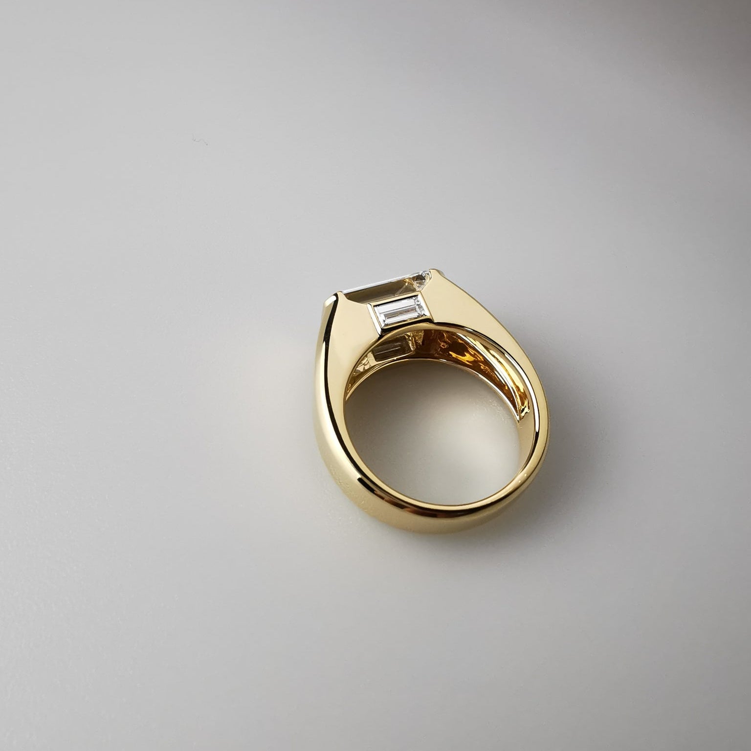 Gold ring with a diamond on a gray background