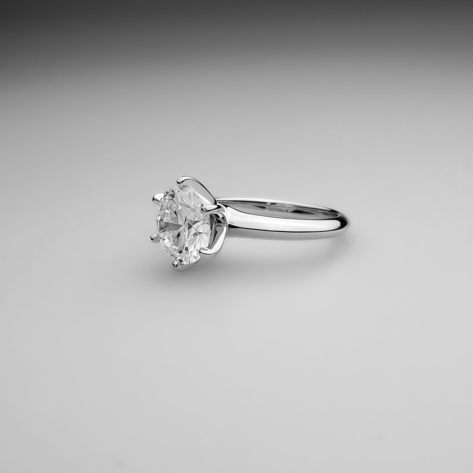 6 Prong Classic Diamond Ring resting on table