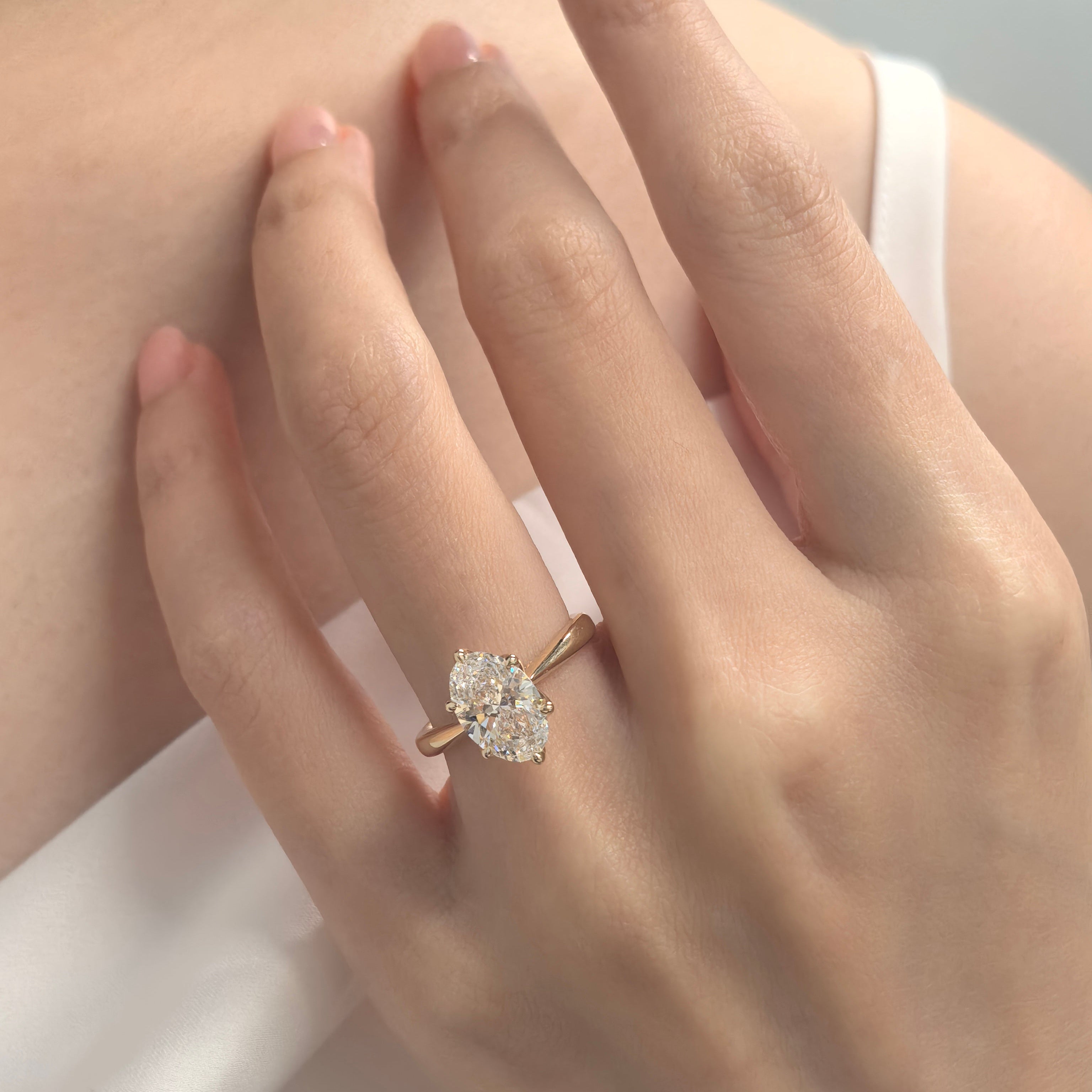 Oval Diamond in Tulip Prong Ring on Hand