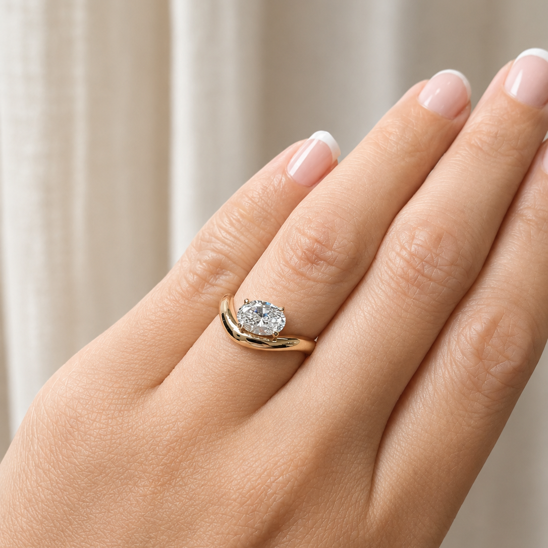 east west oval diamond on wave gold band