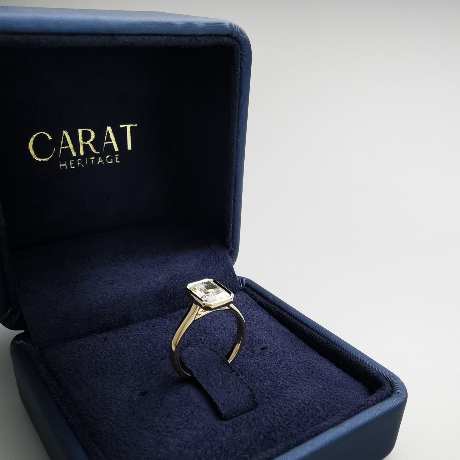 Radiant cut yellow gold ring in box