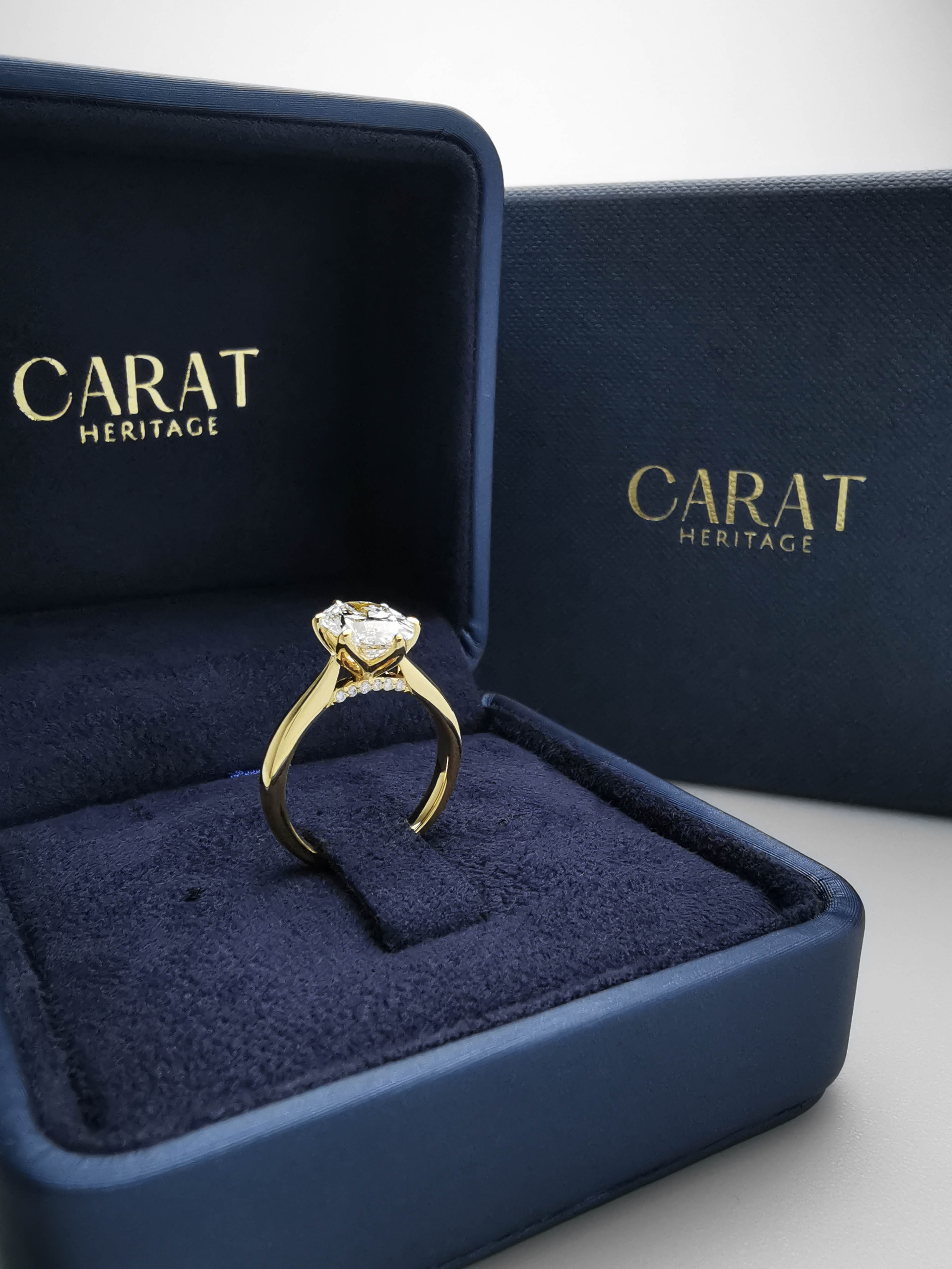 2 carat oval tulip prong setting yellow gold ring in box
