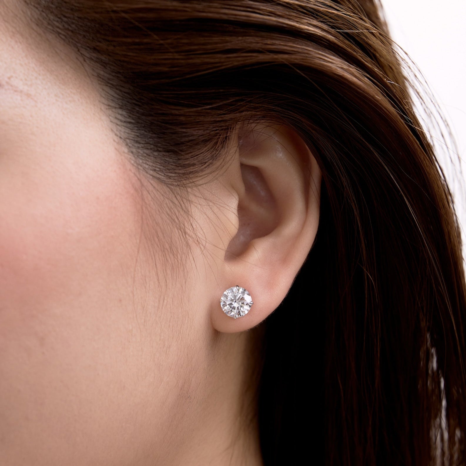 2 carat diamond studs on ear