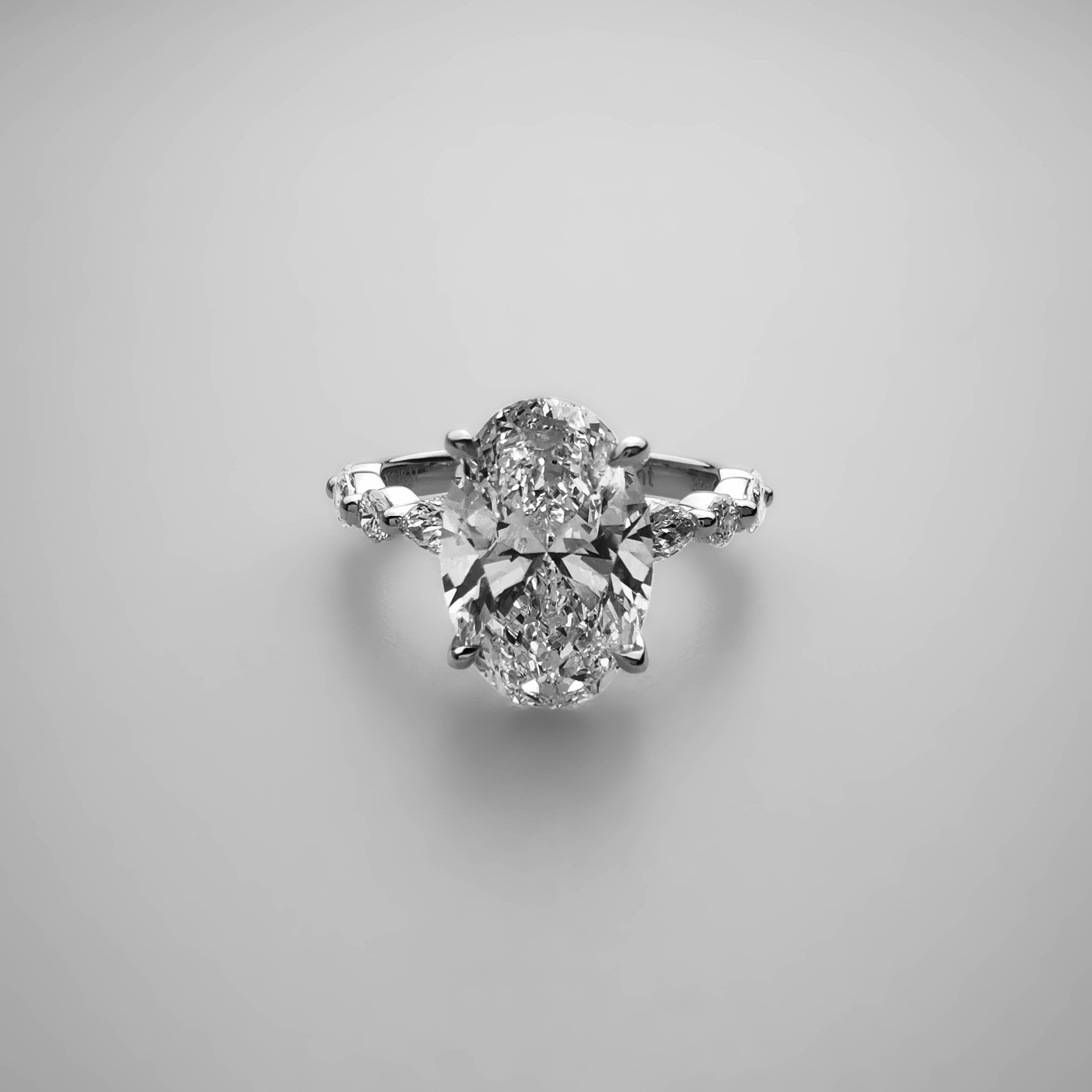 3ct Oval diamond ring with alternating Marquise and Round side diamonds