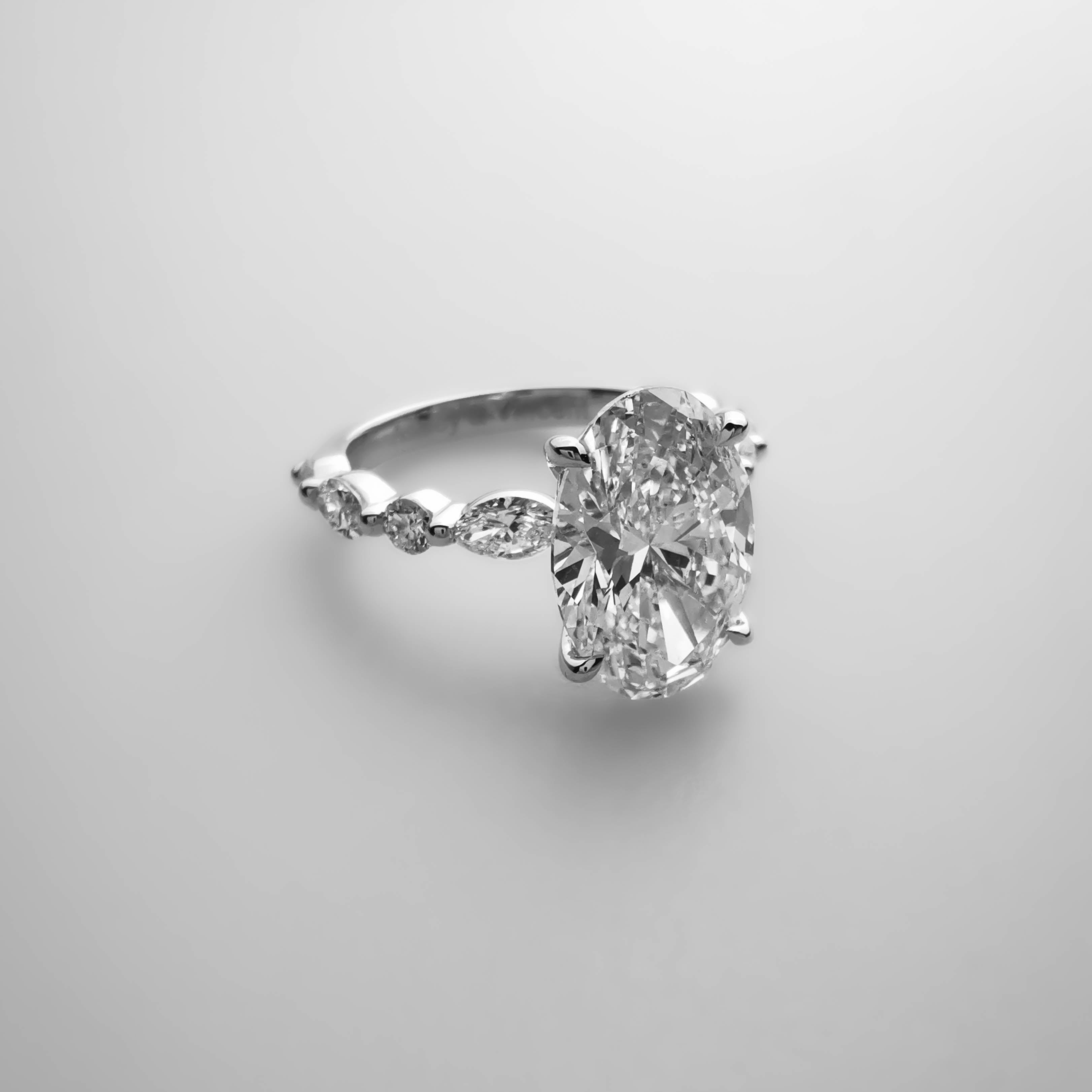 3ct Oval diamond ring with alternating Marquise and Round side diamonds side view 
