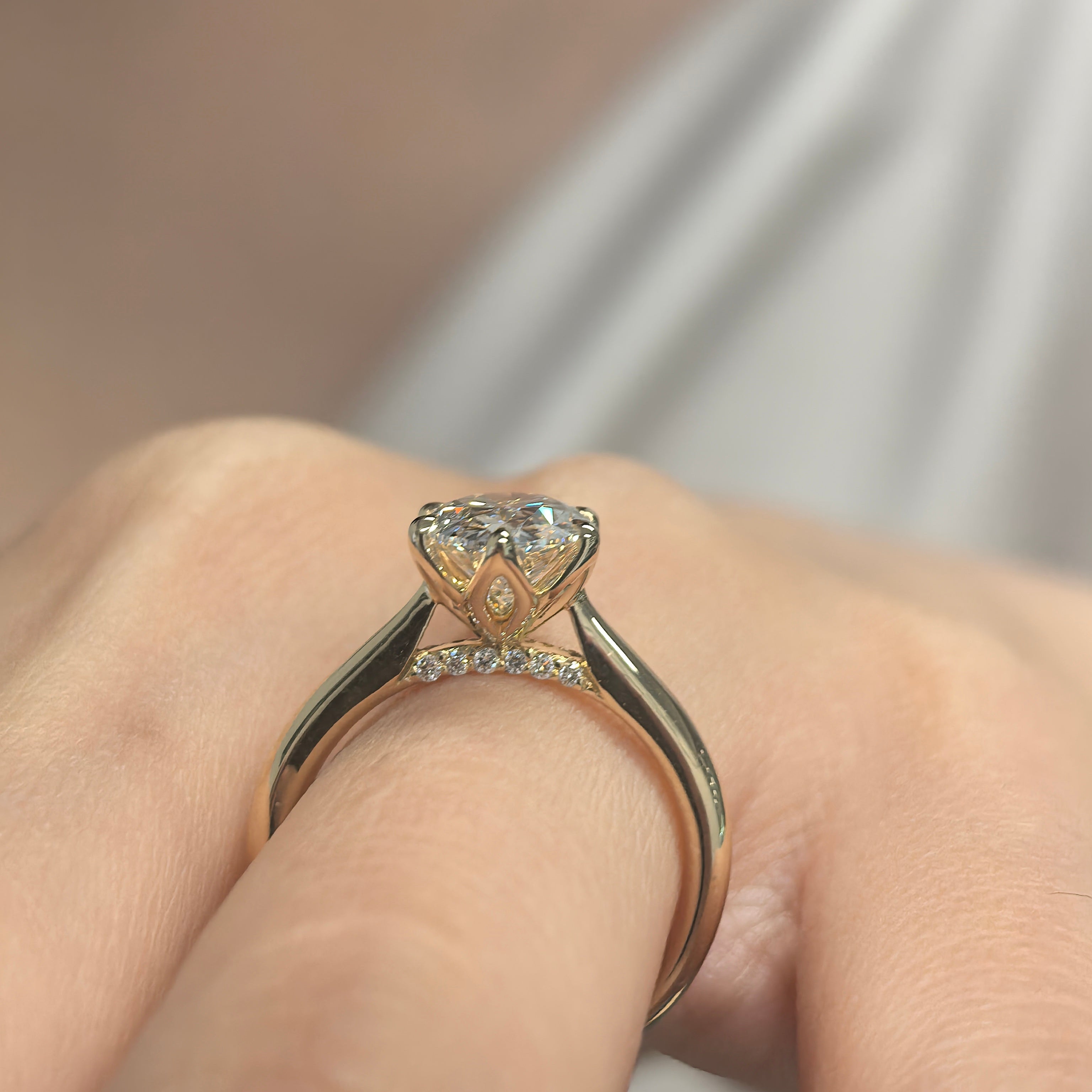 Oval Diamond in Tulip Prong Ring on Hand