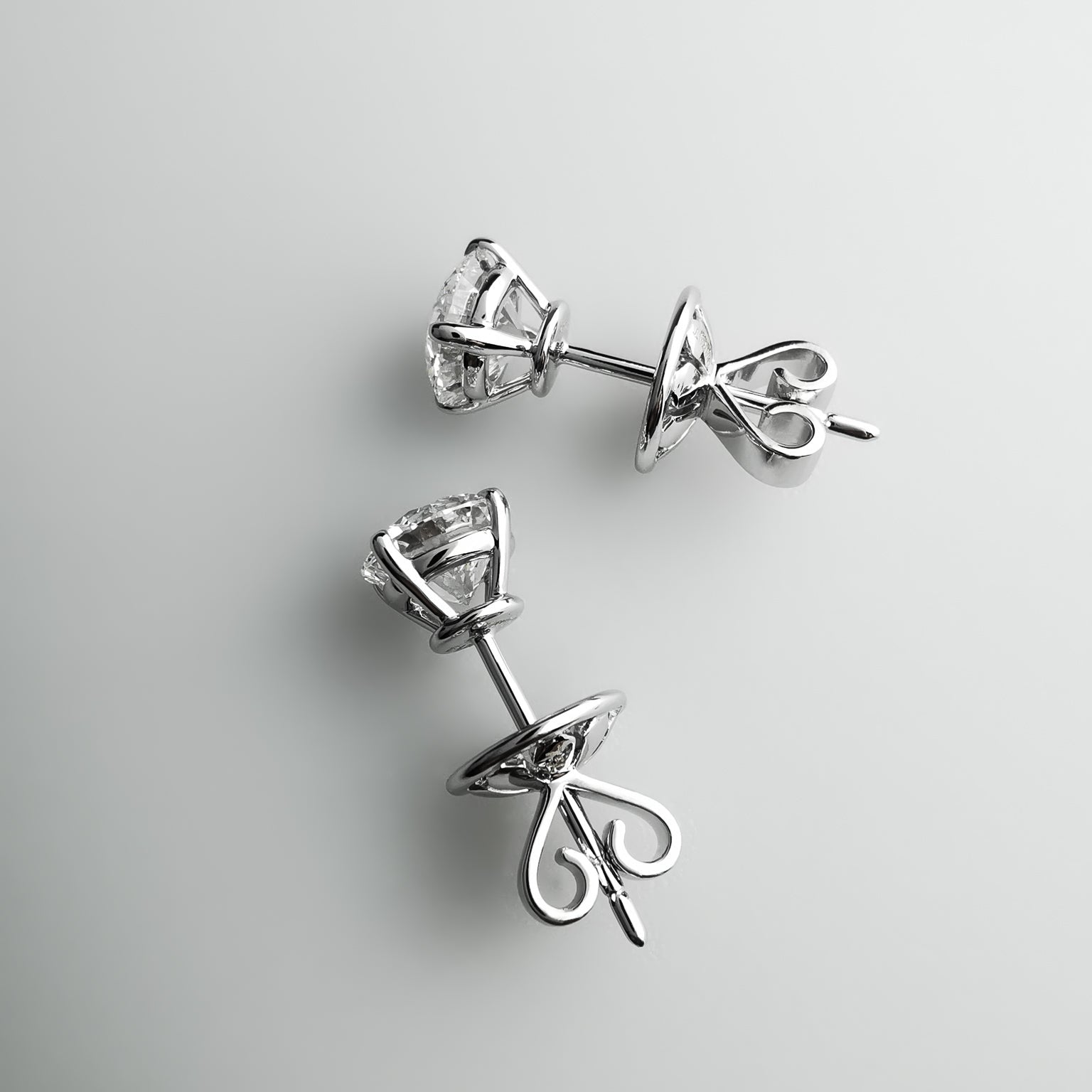 0.5 carat solitaire studs in 18k white gold backing
