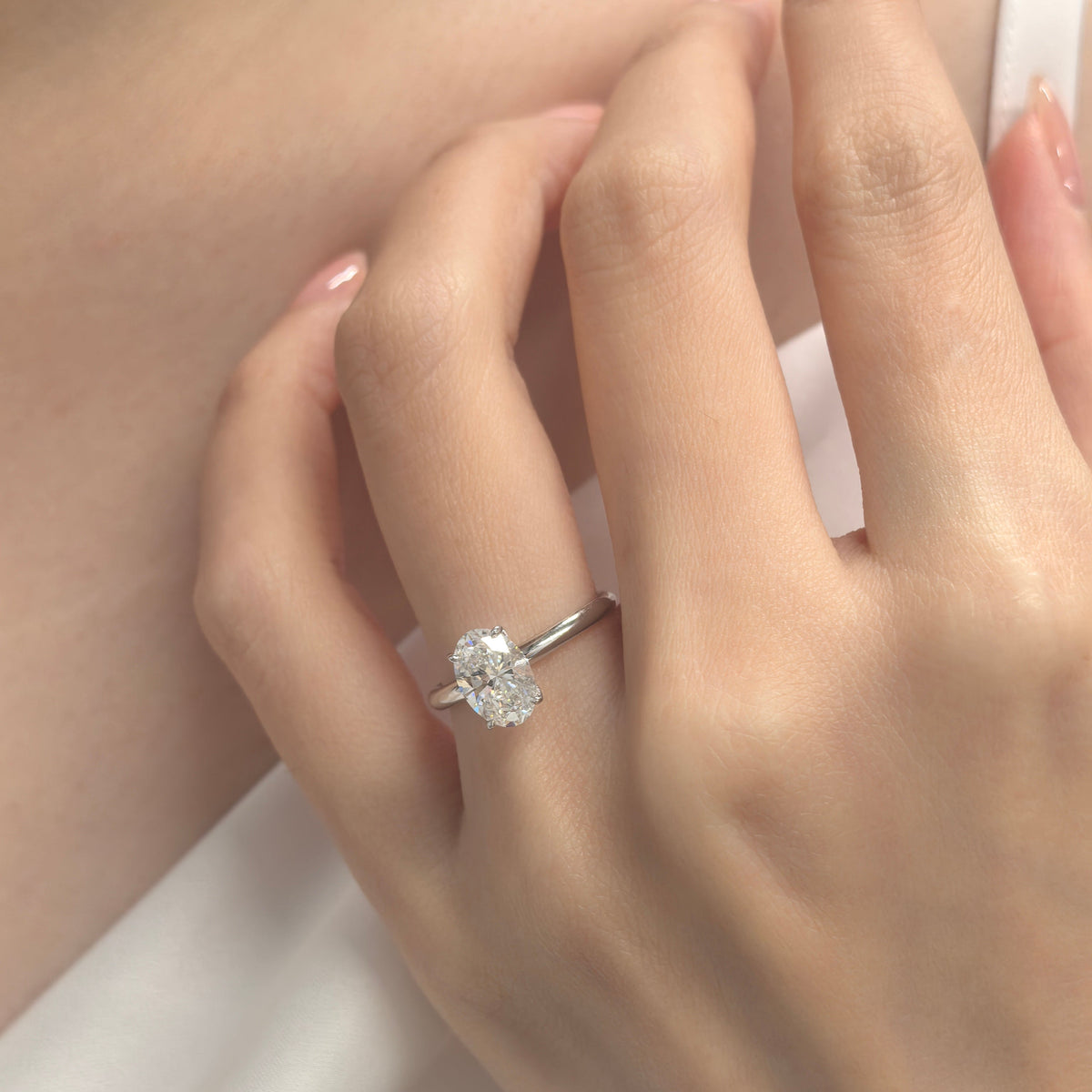 Oval Diamong Ring with classic plain band on finger