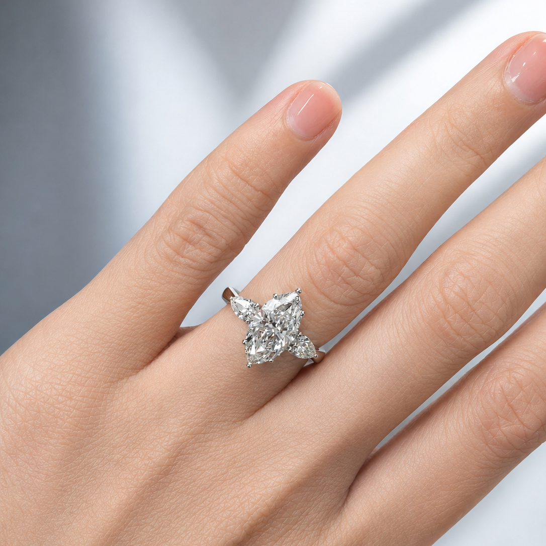 marquise ring with pear side stones on hand